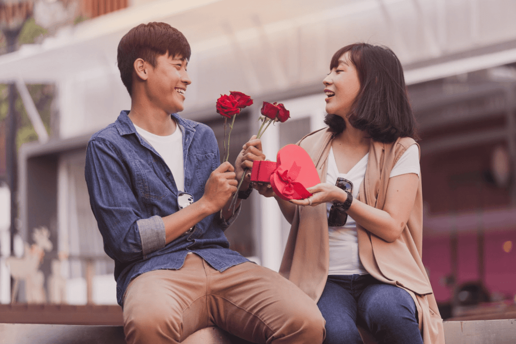 chinese couple exchanging gifts with roses.