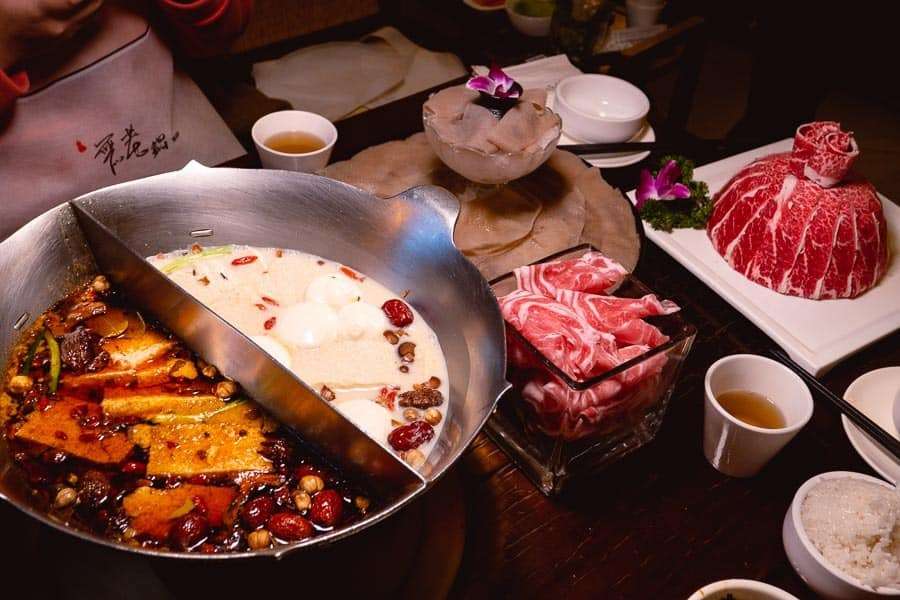 Delicious Chinese hot pot with fresh meats, vegetables, and flavorful broth, perfect for authentic Chinese dining experiences and culinary exploration.