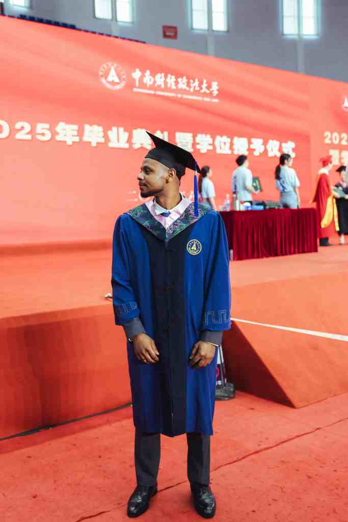 Male Graduate in Cap and Gown at Ceremony of a University in China