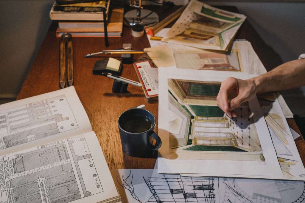 Architectural sketches and interior design drafts on a wooden desk – student portfolio work from the best interior design schools in China