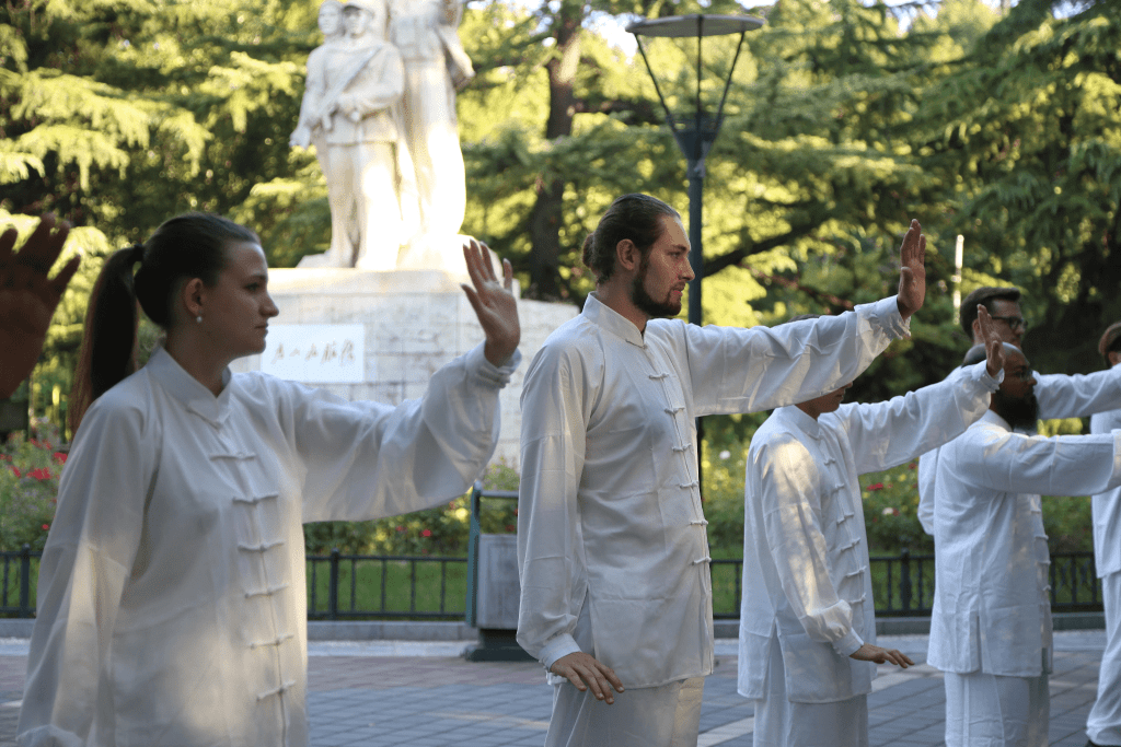 International students practicing tai chi outdoors during a China immersion program