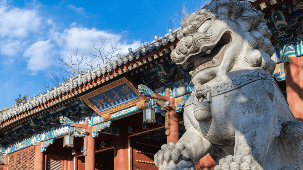 Stone lion at Peking campus entrance gate in Beijing